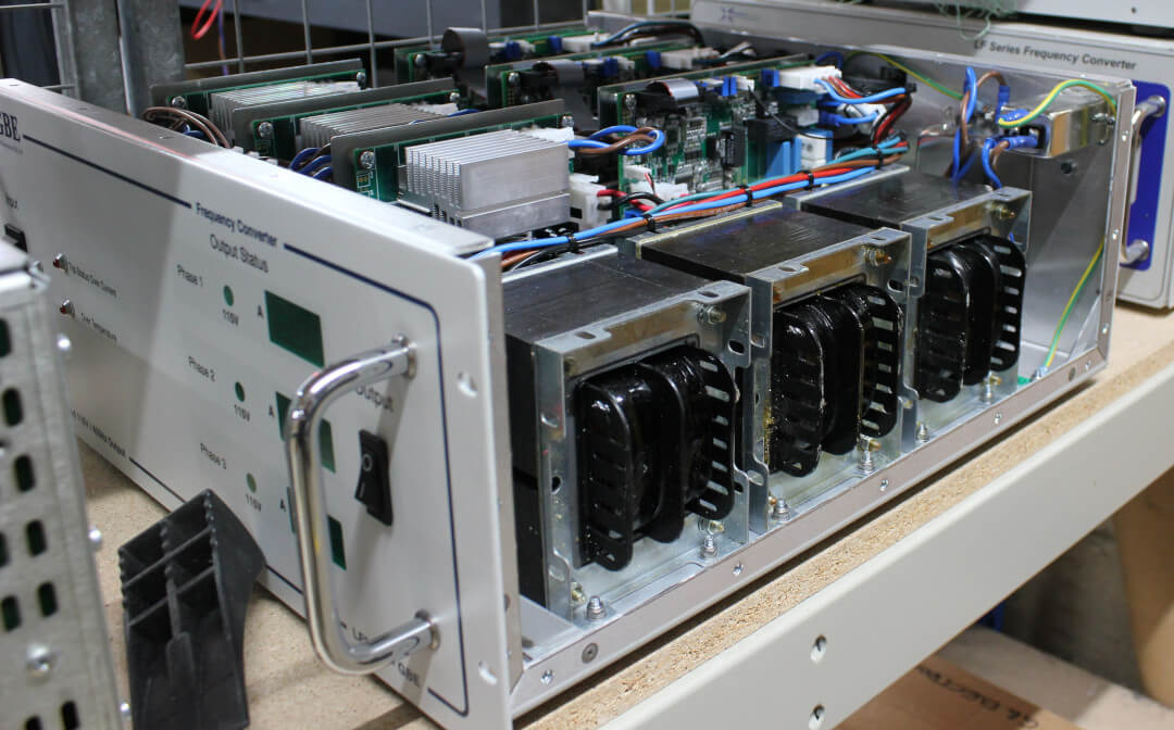 Displaying internal components of a frequency converter. Present are transformers and a number of circuit boards