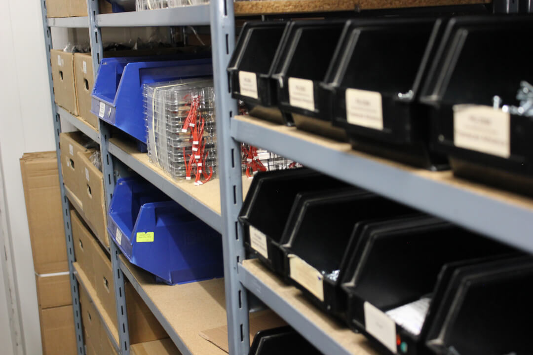 Component storage bins on a shelf