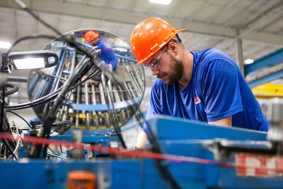A man in a hard hat working within offshore manufacturing