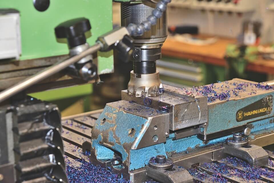 Metal block being cut using a mill