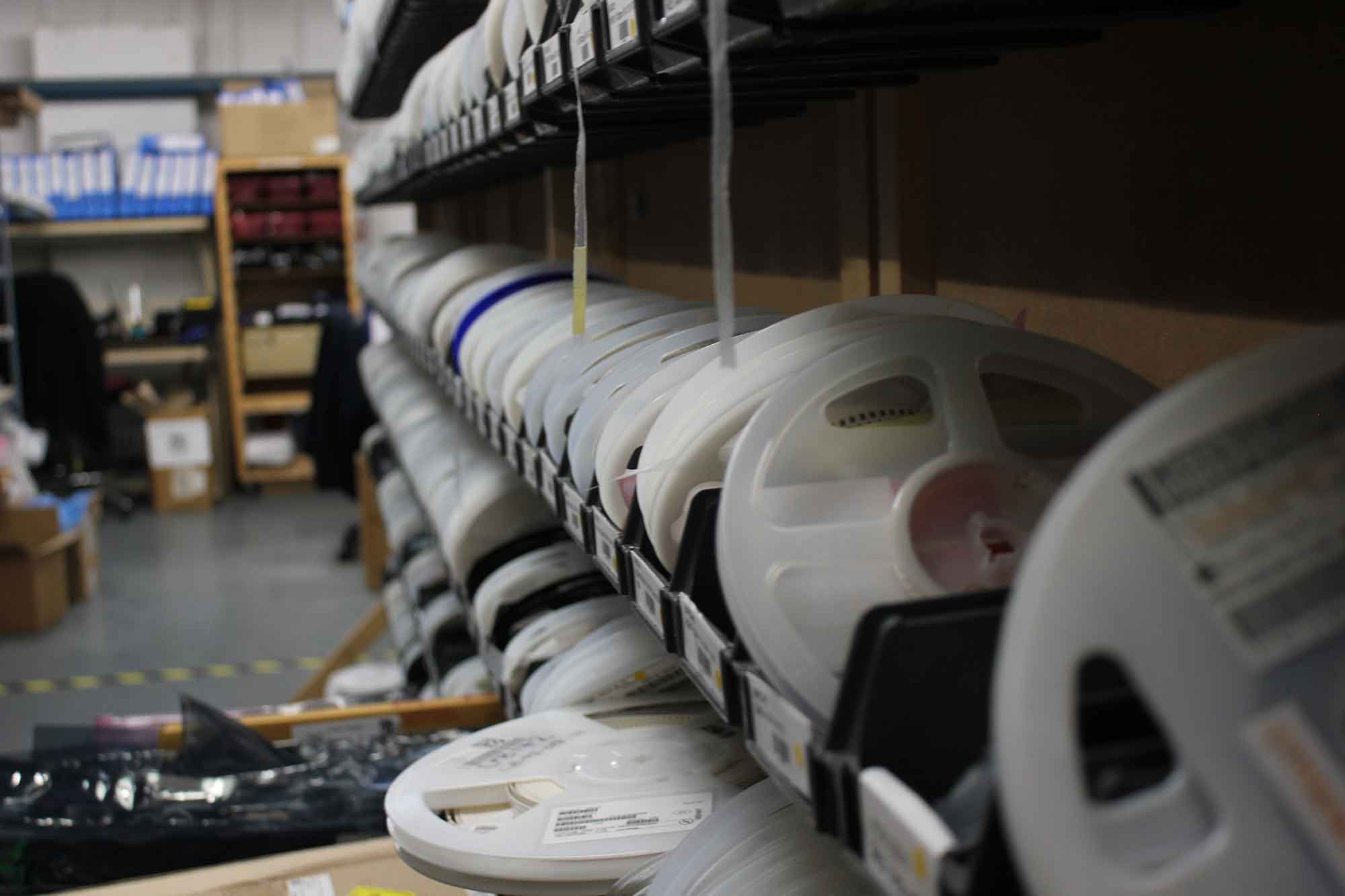Rows of video reel in round plastic cases.