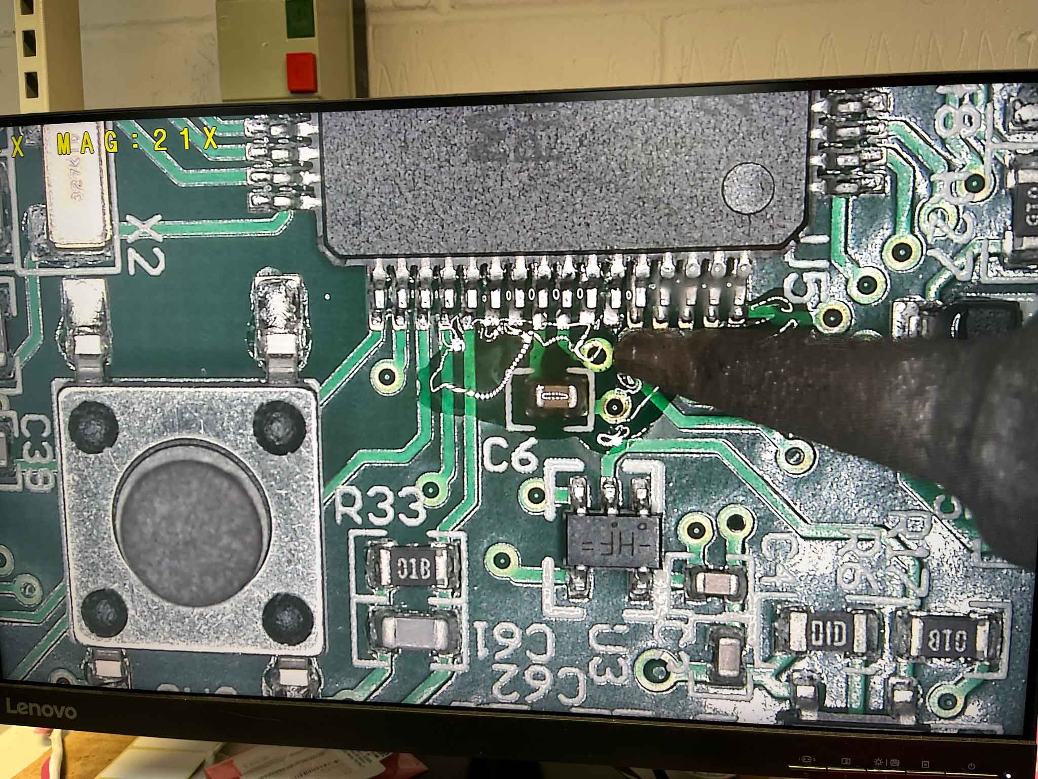 An image of a surface mount component being re-worked using a soldering iron