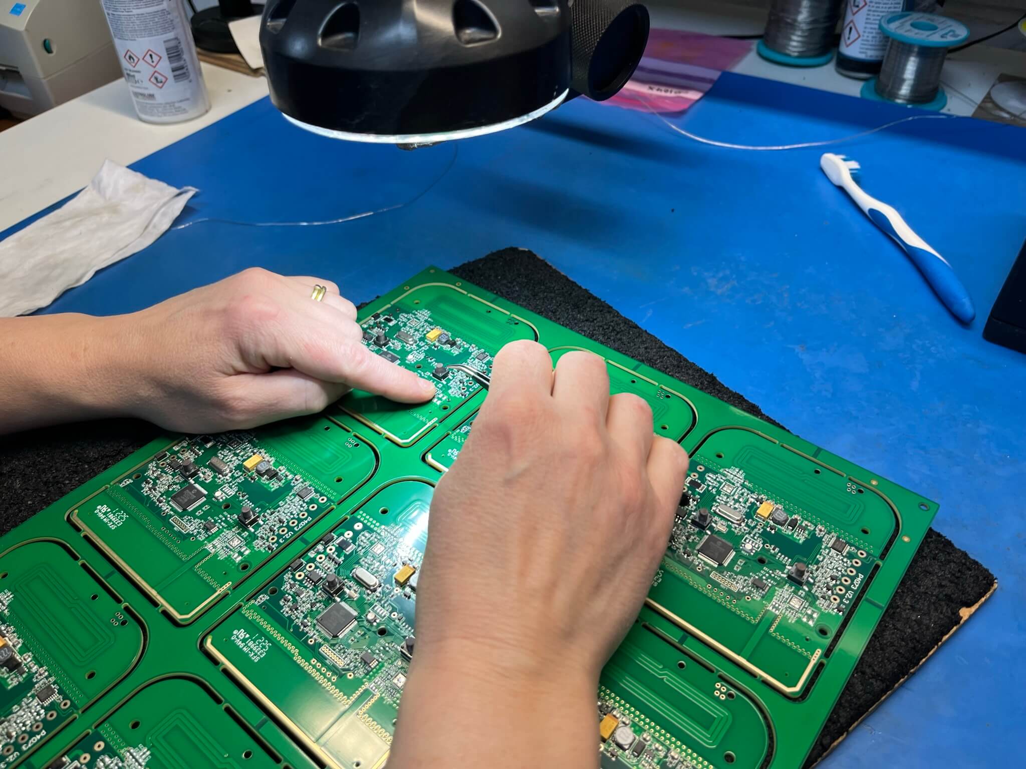 An image of an operator checking component placement under magnification