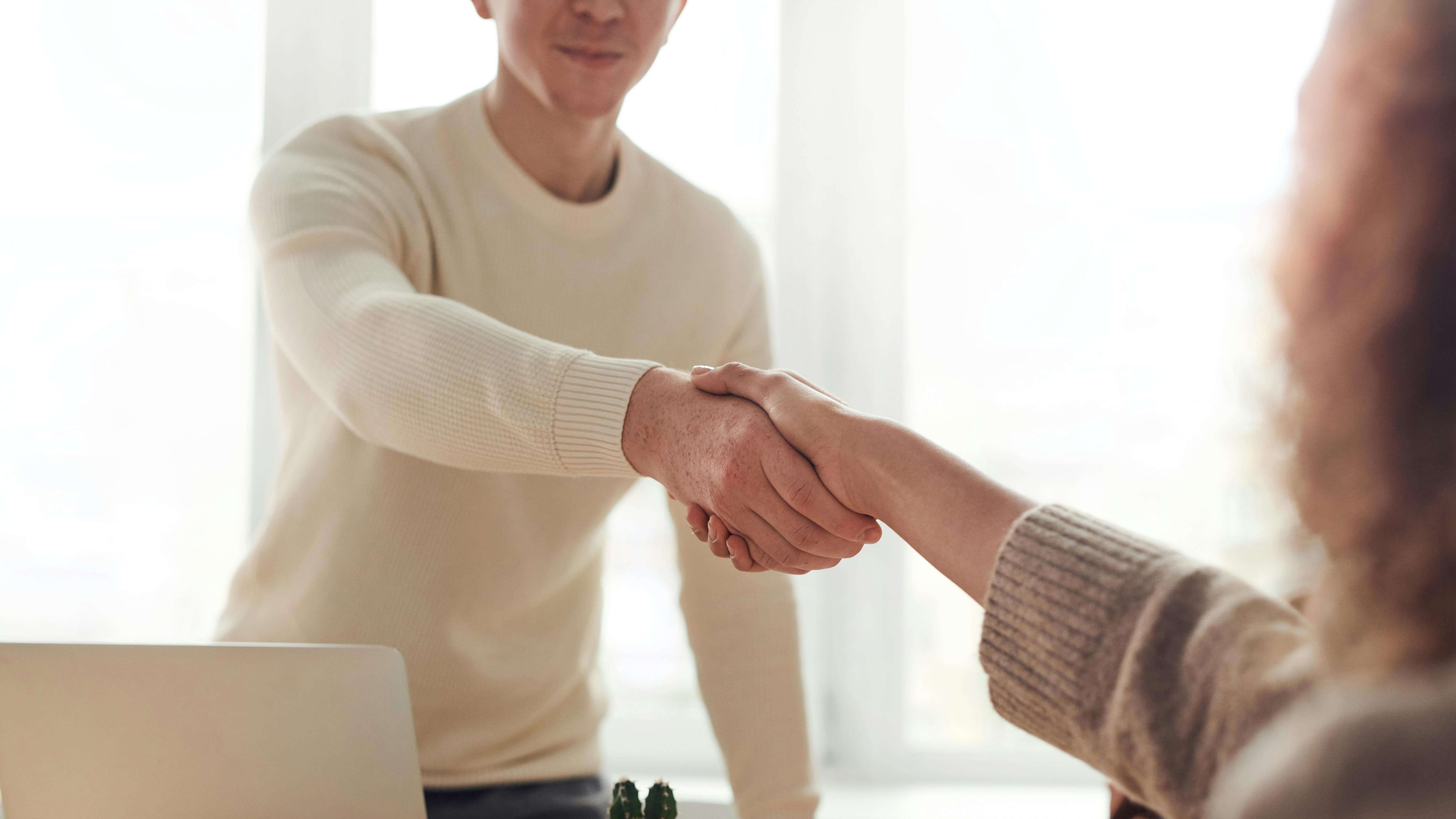 A man and woman shaking hands