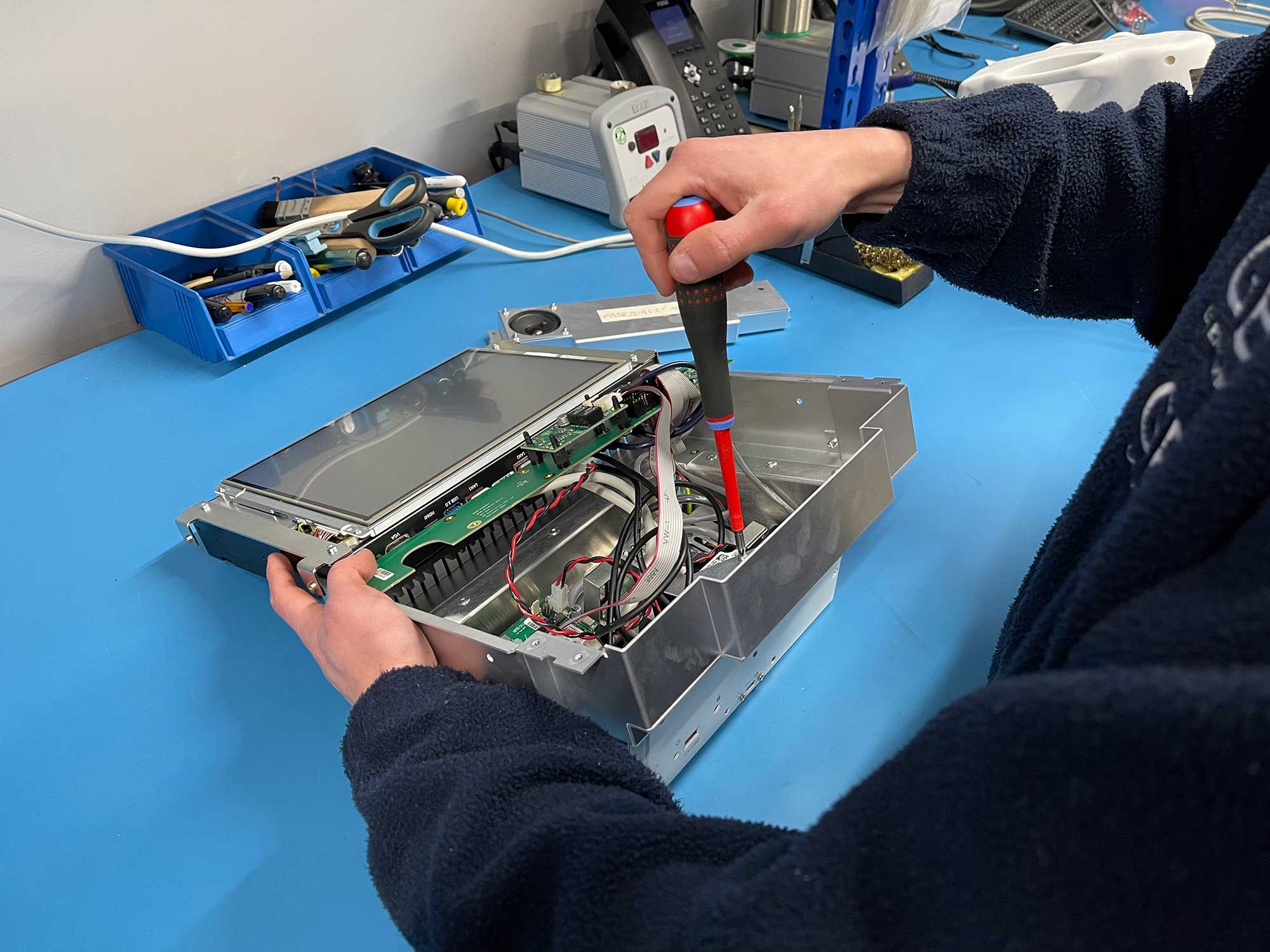 An Engineer fitting a display to a blood kiosk