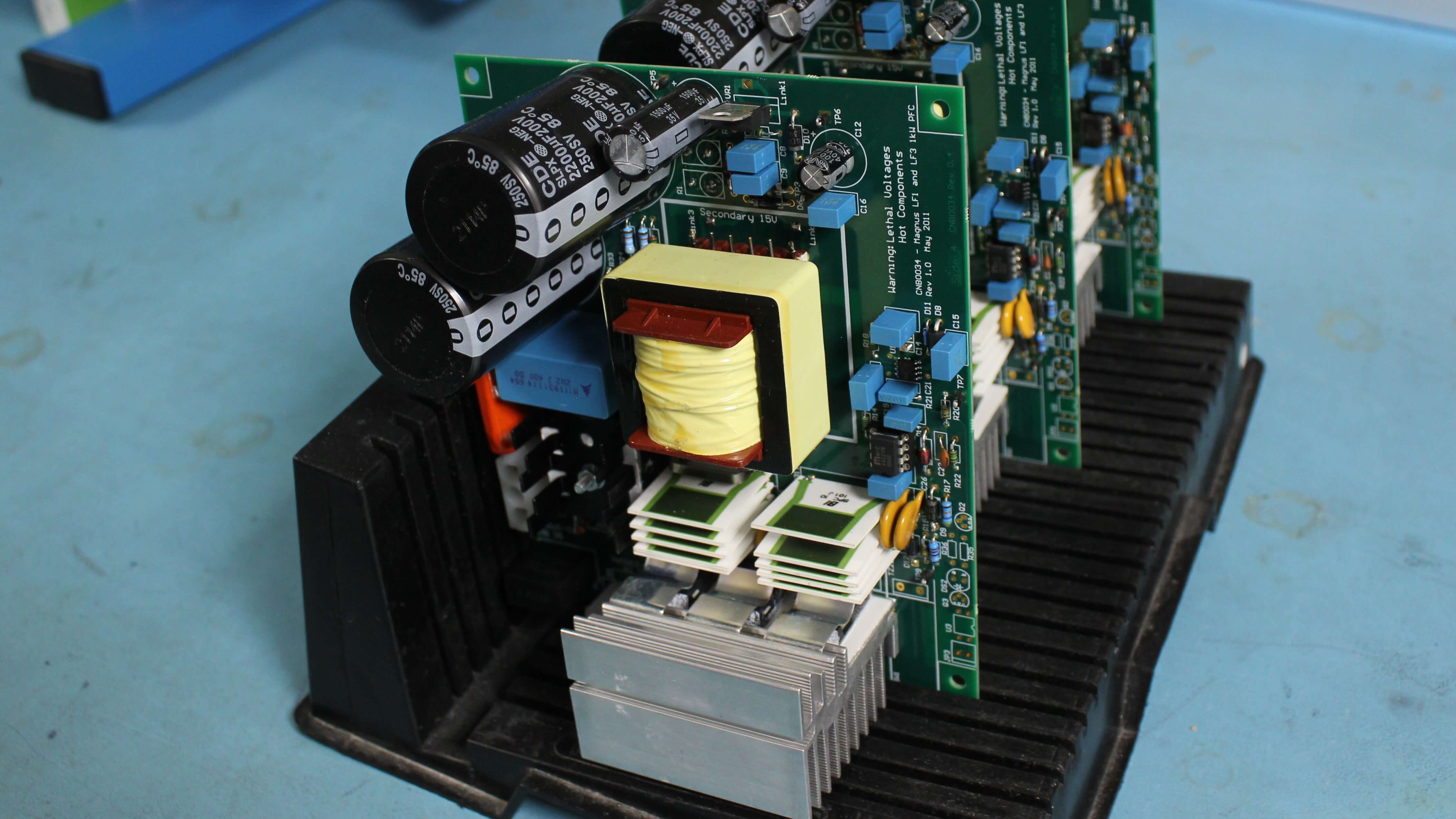 A line of prototype printed circuit boards displayed on a rack