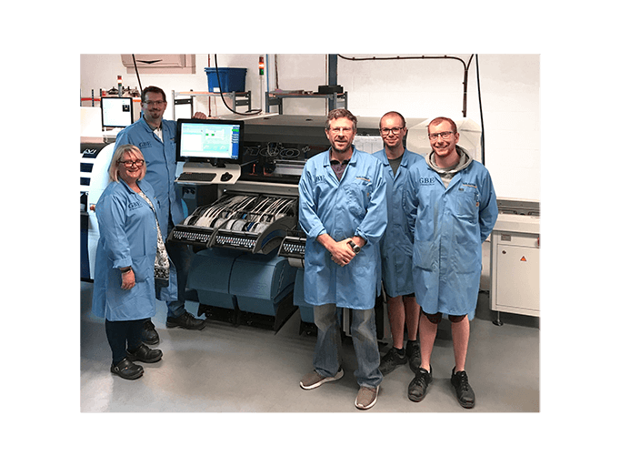 Wildtrax technicians standing in front of the new Iineo + I Pick & Place machine that the Coast t Capital growth grant has helped finance./Coast to Capital Growth Hub logo